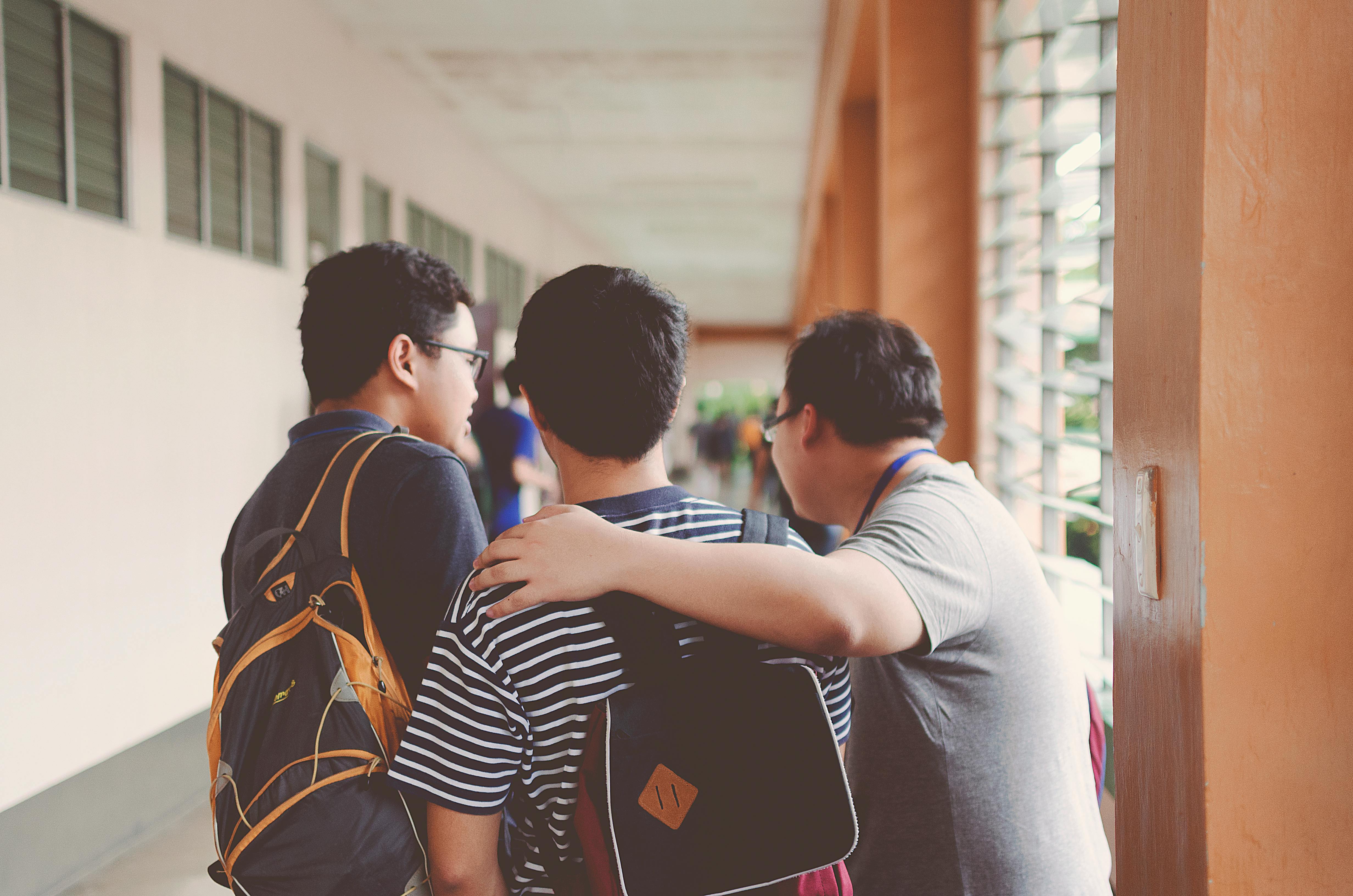 Students collaborating in modern charter school hallway with technology infrastructure