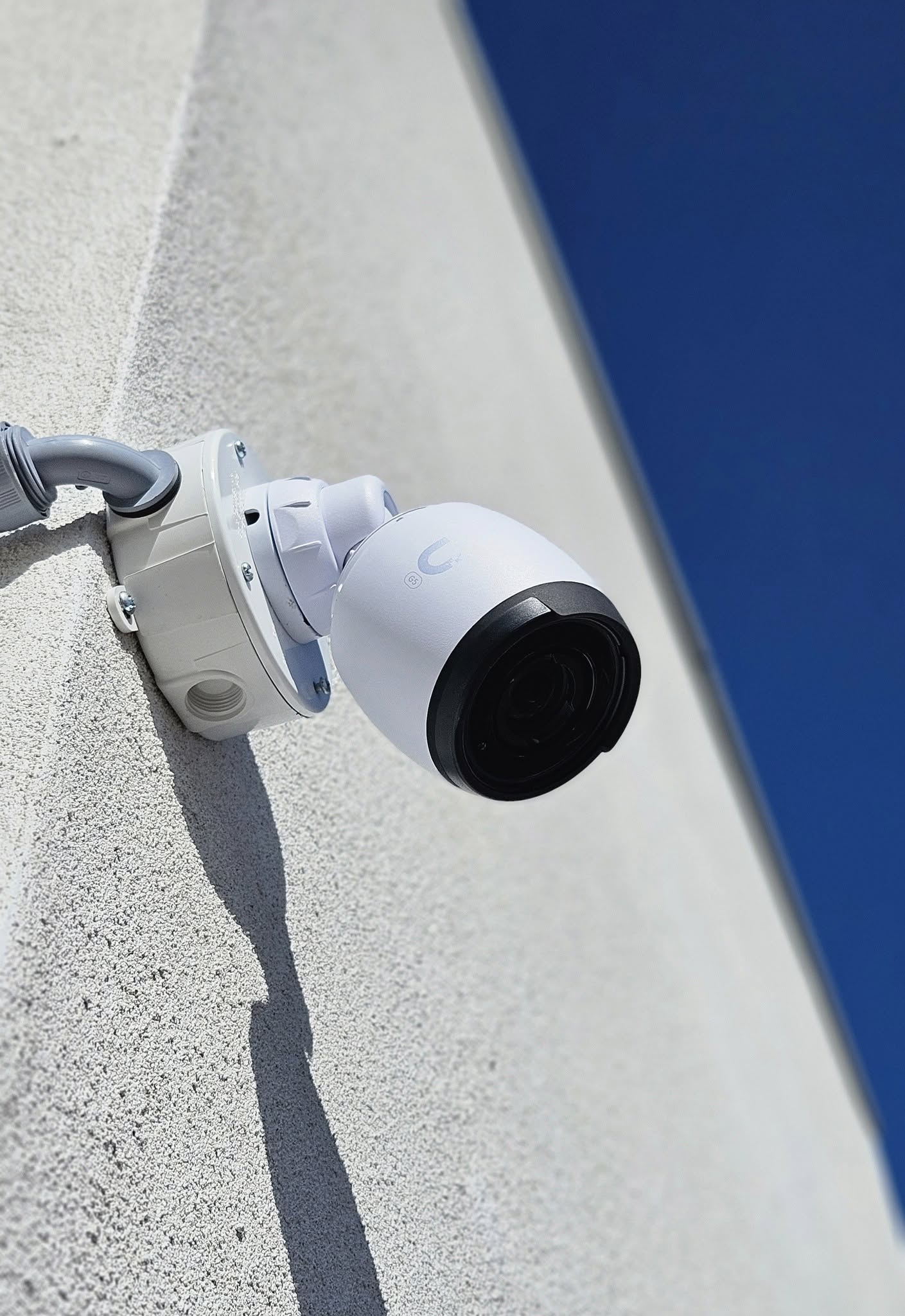 Professional white security camera with night vision mounted on building exterior for surveillance